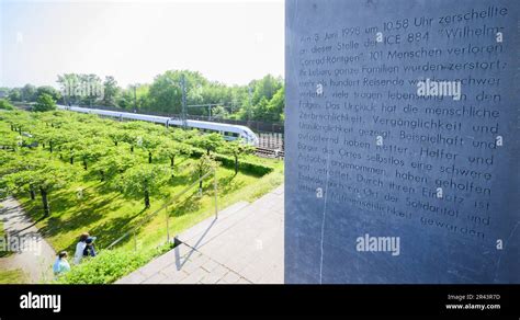 Eschede, Germany. 26th May, 2023. An ICE train passes the memorial for ...