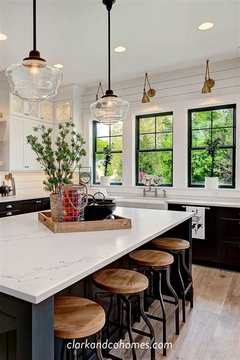 Vintage-inspired pendant lights hang above an expansive island in this Modern Farmhouse kitchen ...