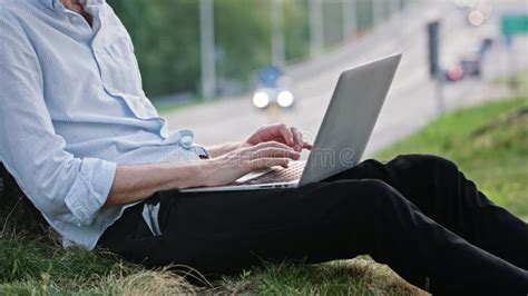 A Young Man Using A Laptop Outdoors Stock Image - Image of communications, lamp: 105278391