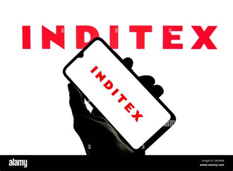 In this photo illustration a Inditex logo seen displayed on a ...