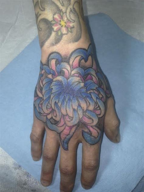 Chrysanthemum tattoo on hand by Shiloah Reina at Damask Tattoo | Chrysanthemum tattoo, Damask ...