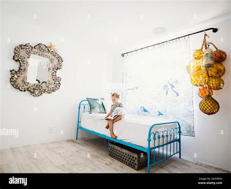 Girl reading book on bed Stock Photo - Alamy