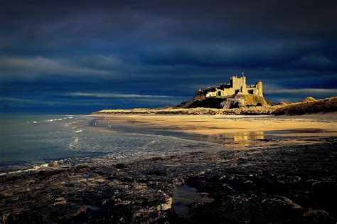 Bamburgh Castle Beach - Photo "Stormy sky over Bamburgh castle ...