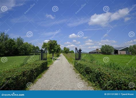 A Gravel Driveway of a Country Property. Viewed through Black Wrought-iron Gates Stock Image ...