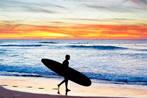 Longboard surfer at sunset | Sports Stock Photos ~ Creative Market