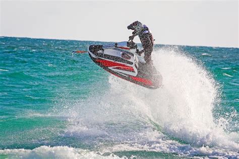 Premium Photo | Young man professional jet ski rider performs many tricks on the waves