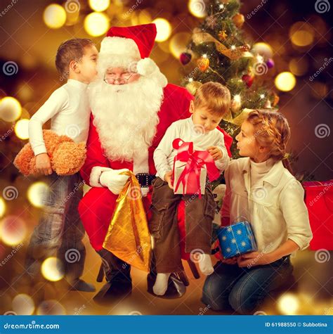 Santa Claus Giving Christmas Gifts To Children Stock Photo - Image of little, gift: 61988550