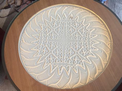 My parents' coffee table that uses a magnet and a metal ball to draw intricate patterns in sand ...