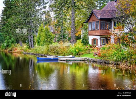 Cottage on a lake Stock Photo - Alamy