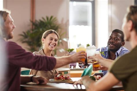 Premium Photo | Young people drinking cocktails at lunch