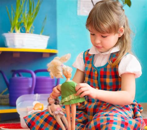 Cute Girl Playing with Toy Doll at Kindergarten Stock Image - Image of clever, portrait: 39892761