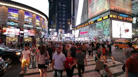 Crowd of people walking in Times Square New York City at night 30p ...