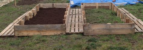 Raised beds and paths made out of recycling pallets. These two, soon to be vegetable beds, were ...