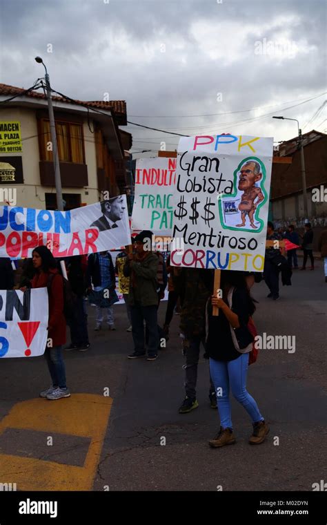 A protester carries a placard accusing Peruvian President Kuczynski of ...