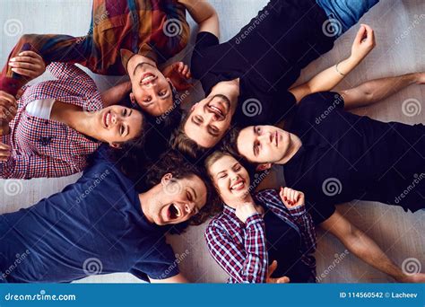 A Group of Friends are Laughing Lying on the Floor in Room. Stock Photo - Image of laughing ...