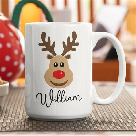 a white coffee mug with reindeer's head on it and the word william written in black