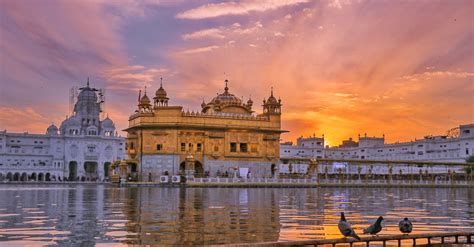 Golden temple near water in evening · Free Stock Photo