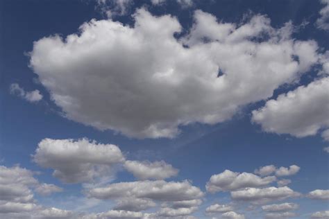 white fluffy clouds in a blue sky 21631896 Stock Photo at Vecteezy