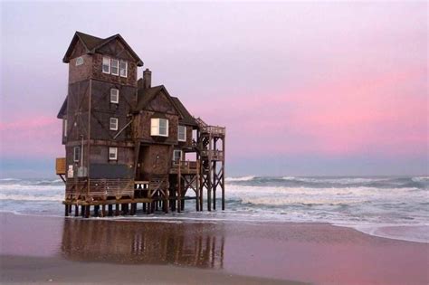 Abandoned beach house in the Outer Banks, North Carolina, slowly being reclaimed by the sea ...