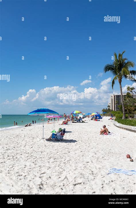 Vacationers in Naples, Florida enjoying beach activities. Sunbathing ...