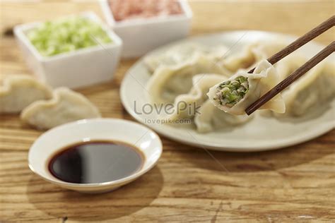 Precise Close Up Of Dumplings Picked Up By Chopsticks Picture And HD ...