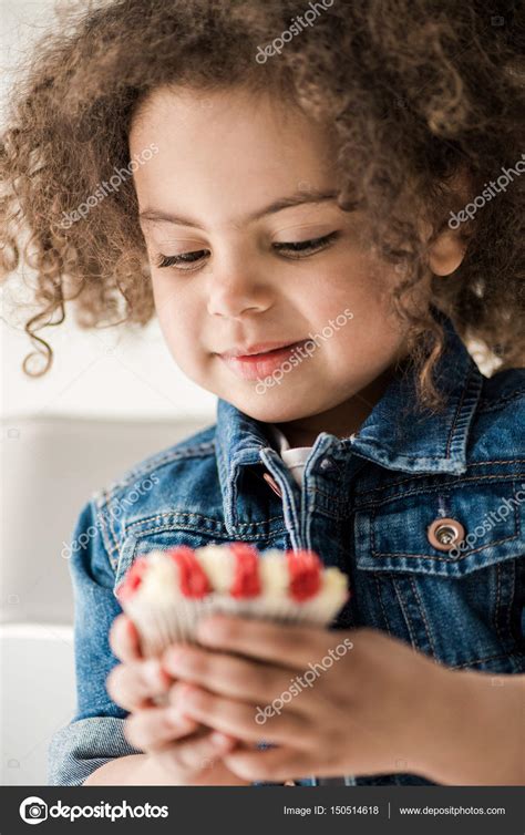 Girl with american flag muffin — Stock Photo © ArturVerkhovetskiy #150514618