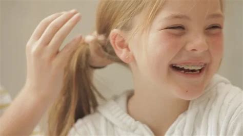 Giggling young girl getting her hair put... | Stock Video | Pond5
