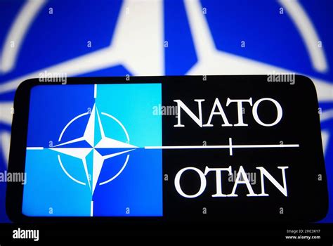 In this photo illustration, a NATO (North Atlantic Treaty Organization, also called the North ...