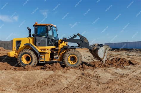 Premium Photo | Bulldozer or loader moves the earth at the construction ...