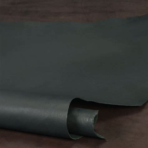 a roll of black leather sitting on top of a table