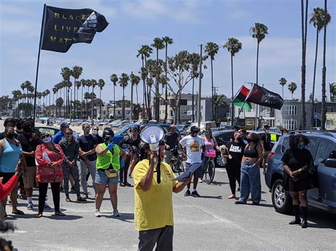 Protest organizer accused of driving through crowd faces new charges in Seal Beach brawl • Long ...