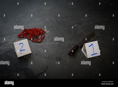 Evidence and crime scene markers on black background Stock Photo - Alamy