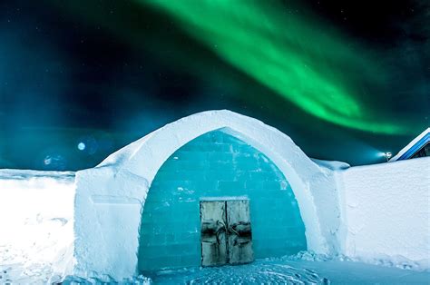 Icehotel Sweden, the iconic entrance with northern lights in the sky. | Sweden