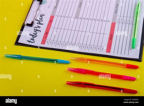 Set colorful pens and week calendar close-up Stock Photo - Alamy