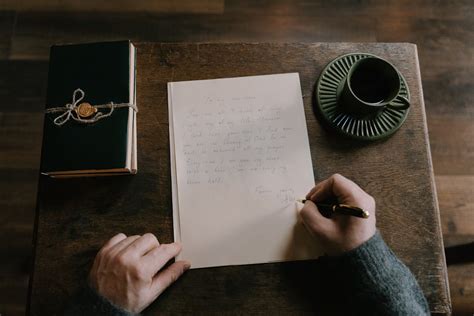 Man Writing in a Book · Free Stock Photo