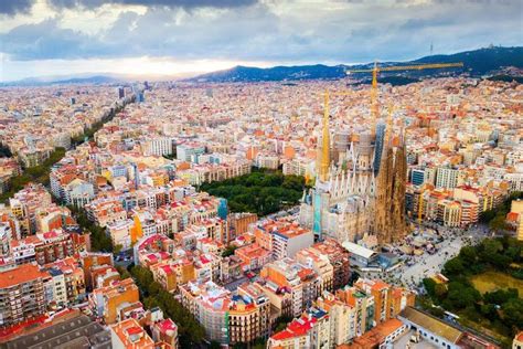 an aerial view of barcelona, spain with the cathedral in the foreground and surrounding buildings