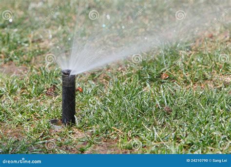 Watering lawn in spring stock photo. Image of garden - 24210790