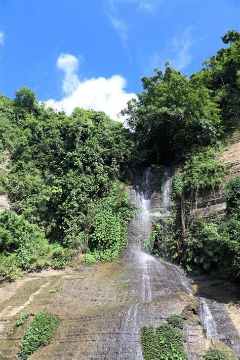 Natural waterfall view in the forest or mountain. Beautiful sky view with the mountain. green ...