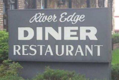 the sign for river edge diner restaurant is shown in front of some bushes and trees