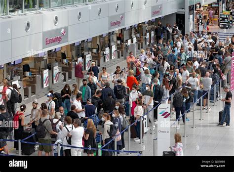 Passengers wait for check-in in front of the Eurowings check-in counter ...