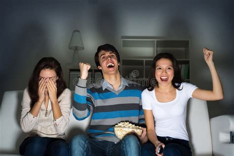 Group Of Young People Watching TV On The Couch Royalty Free Stock Image - Image: 30740666