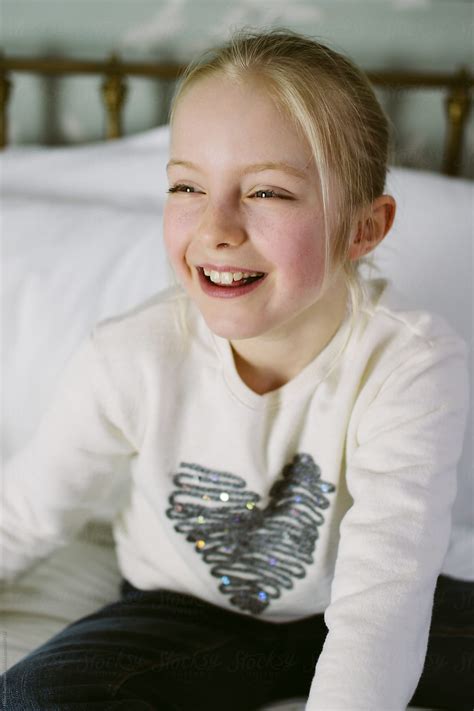 "A Little Girl Laughing" by Stocksy Contributor "Helen Rushbrook" - Stocksy