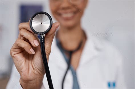 Cardiology doctor, stethoscope closeup and black woman in healthcare, heart wellness and ...