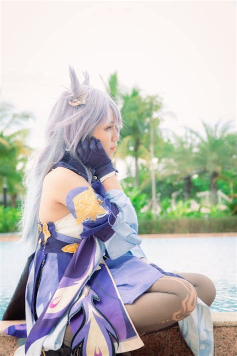 A Female Cosplayer Wearing a Purple Costume · Free Stock Photo