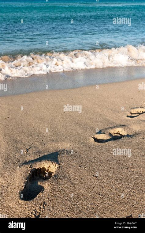 Footprints in beach sand Stock Photo - Alamy