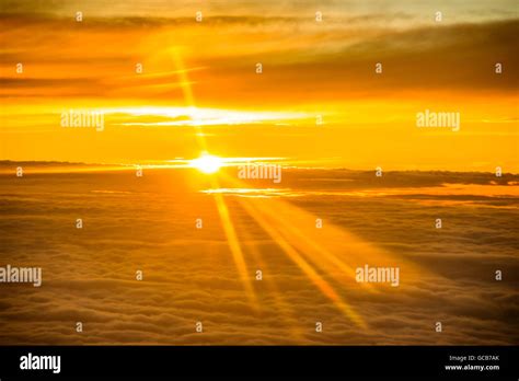 Sunset seen from airplane above the clouds Stock Photo - Alamy