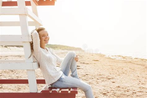 Young Woman Sitting On Beach Lifeguard Chair Stock Photo - Image: 49604862