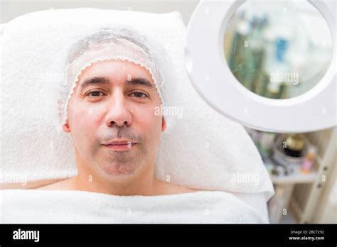 Man lies near magnifier mirror on white background Stock Photo - Alamy