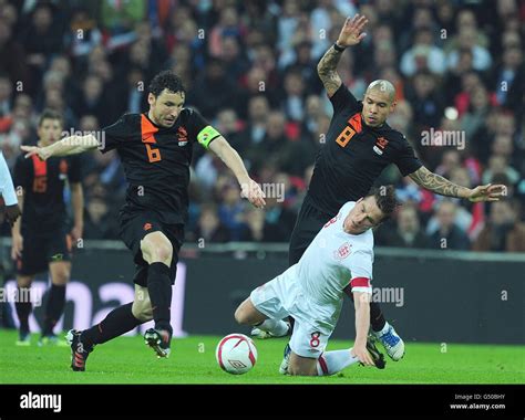 Netherlands' Mark Van Bommel (left) and Nigel De Jong (right) in action ...