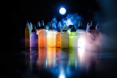 Vape Concept. Smoke Clouds And Vape Liquid Bottles On Dark Background ...